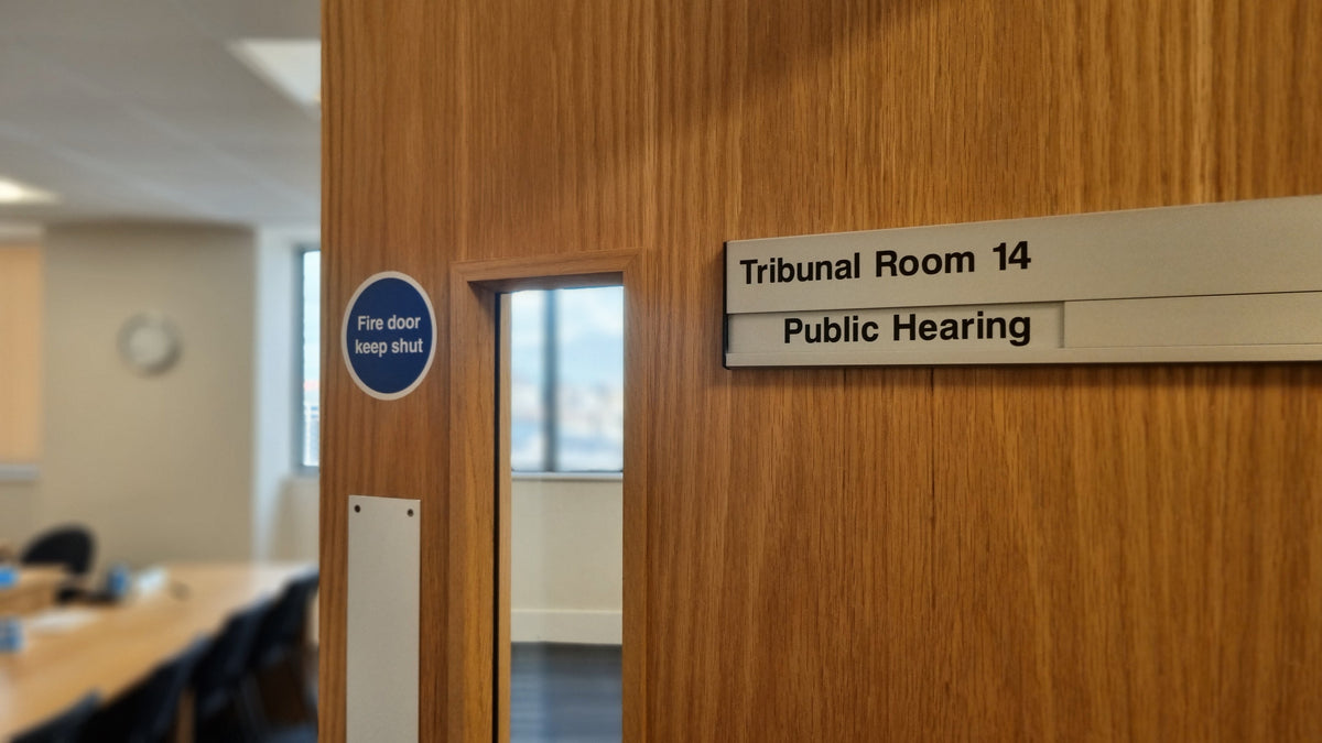 A real Tribunal hearing room door - the room where this process actually happens.